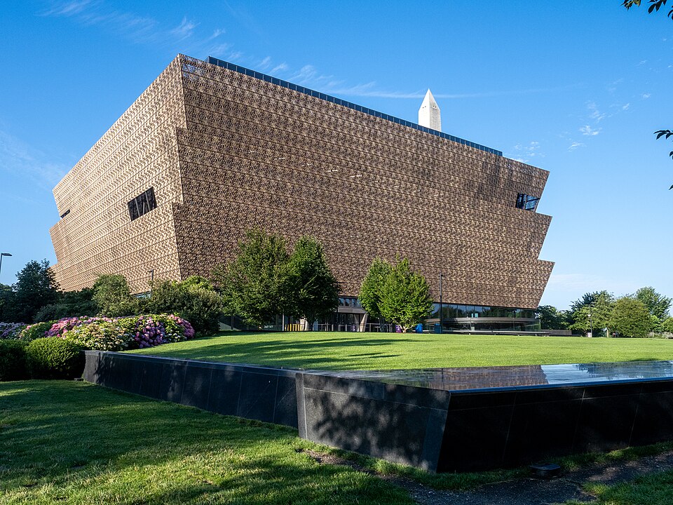 The National Museum of African American History and Culture, with three widening tiers of bronze-colored panels.